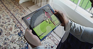 Composite of man sitting at home, watching rugby match on tablet