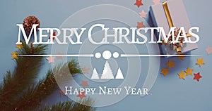 Composite of merry christmas greetings text over christmas decorations