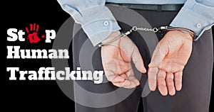 Composite of midsection of caucasian businessman with handcuffs and stop human trafficking text