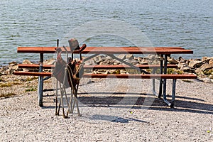 A composite picnic bench and table with an old washup garden chair