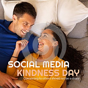 Composite of social media kindness day text and happy caucasian young couple lying on bed at home