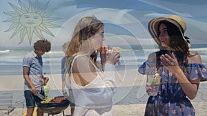 Composite video of waving argentina flag over two caucasian women enjoying drinks at the beach