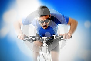 Composite of young aggressive sport man riding mountain bike in frontal view