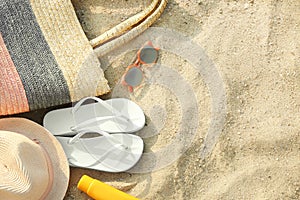 Composition with  accessories on sand, flat lay. Space for text