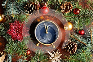 Composition with alarm clock, fir branches and decorations on color background. Christmas countdown