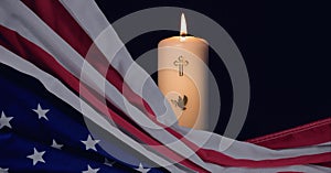 Composition of american flag and lit candle with christian cross on black