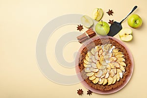 Composition with apple pie and ingredients on background, top view