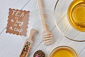 Composition with aromatic healthy tea on wooden background.