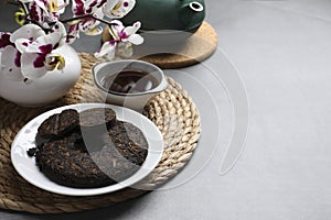 Composition with aromatic pu-erh tea on grey table. Space for text