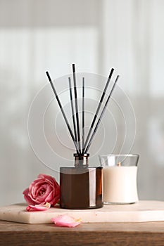 Composition with aromatic reed air freshener on wooden table