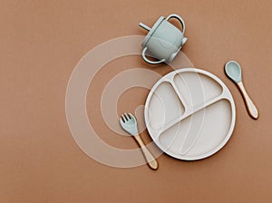 Composition with baby food accessory on brown background