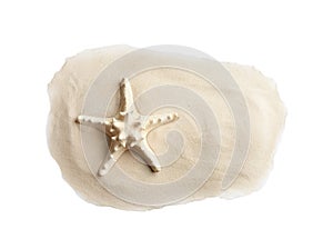 Composition with beach sand and sea star on white background