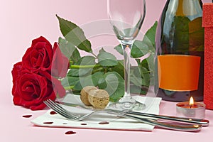 A composition of a beautiful bouquet of roses, glasses and a bottle of champagne creates a romantic card or poster. The concept of