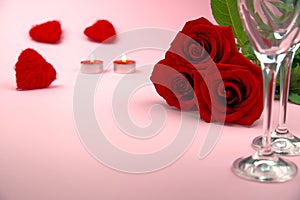 A composition of a beautiful bouquet of roses, glasses and a bottle of champagne creates a romantic card or poster. The concept of
