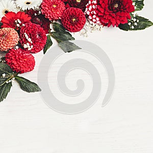 Composition with beautiful dahlia flowers on white wooden background, above view. Space for text