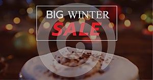 Composition of big winter sale text over christmas hot chocolate decoration in background