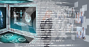 Composition of binary coding over businessman looking at screen with medical digital data