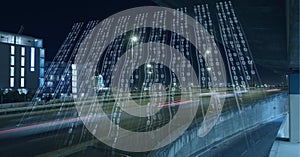 Composition of binary coding over cityscape at night