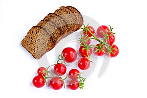 Composition of black bread slices and bunch of tomatoes