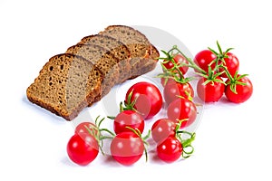 Composition of black bread slices and cherry tomatoes