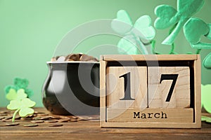 Composition with block calendar on table. St. Patrick`s Day celebration