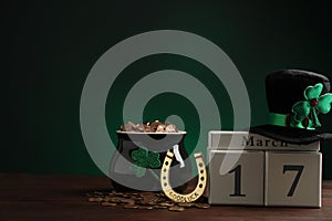 Composition with block calendar on wooden table, space for text. St. Patrick`s Day celebration