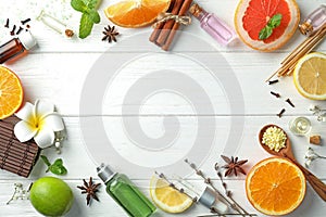 Composition with bottles of citrus essential oils on wooden table