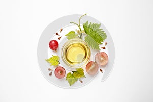 Composition with bowl of natural grape seed oil on background, top view. Organic cosmetic