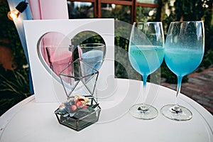 Composition from a box with wedding rings, glasses of champagne, candles and other decor