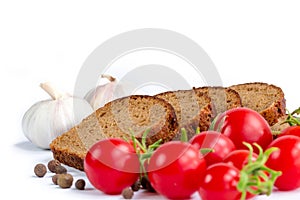 Composition of bread, bunch of cherry tomatoes and garlic