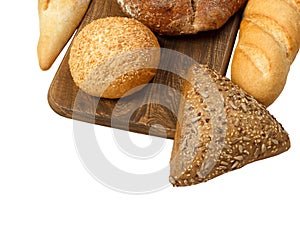 Composition with bread and rolls on cutting board isolated on white