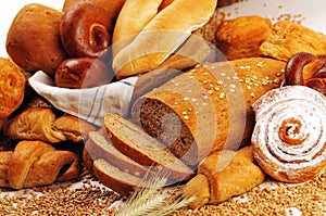 Composition with bread and rolls in wicker basket, combination of sweet breads and pastries for bakery or market with wheat