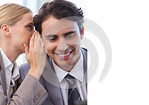 Composition of businesswoman whispering in ear of businessman