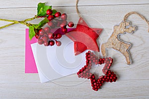 Composition of cards with copy space and christmas decorations on wooden background