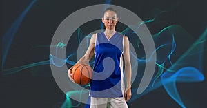 Composition of caucasian female basketball player holding ball on grey background