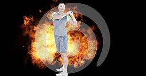 Composition of caucasian female golf player holding golf club over flames on black background