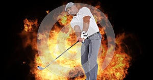 Composition of caucasian male golf player holding golf club over flames on black background