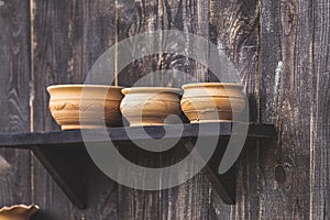 Composition with ceramic bowls on dark wooden surface. Conception old rustic style. Shallow depth of the field, copy space for you