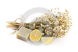 Composition with chamomile flowers and homemade cosmetic, essential oil, sopa,  on white background, top view
