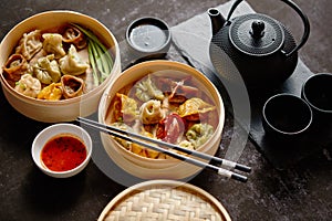 Composition of chinese food. Mixed kinds of dumplings from wooden bamboo steamer