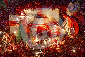 Composition with christmas gifts, electric garland and tinsel