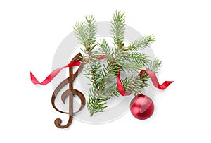 Composition with Christmas tree branch, decor and wooden music note on white background