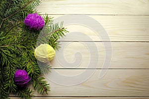 Composition with Christmas tree and yarn balls as decorations on wooden background