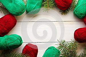 Composition with Christmas tree, yarn balls as decorations on wooden background