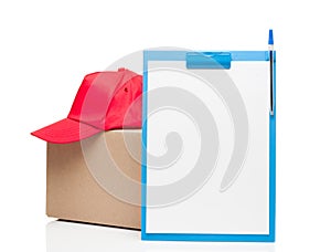 Composition with clipboard red cap and cardboard box