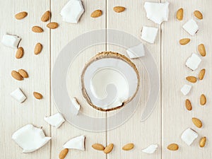 Composition with coconut and almonds on the wood.