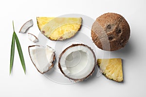 Composition with coconuts, juicy and leaves  slices on white background, top view