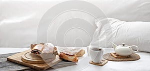 Composition with coffee and fresh buns in bed copy space