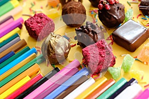 Composition of colored pencils and beautiful sweets