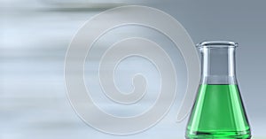 Composition of conical flask of green liquid, with blurred copy space
